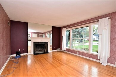 Living room has wood flooring, fireplace and large