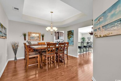 Dining area featuring baseboards, a raised ceiling