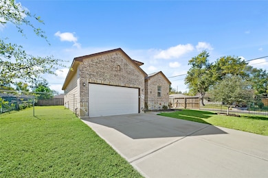 View of the spacious driveway and two-car garage, providing ample off-street parking.