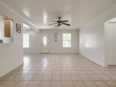 Tiled entrance foyer featuring ceiling fan, plenty