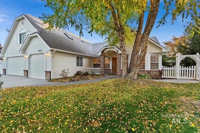 View of front of house featuring brick siding, a garage, driveway, and a shingled roof