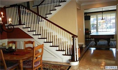 Polished travertine and distressed wood floors.