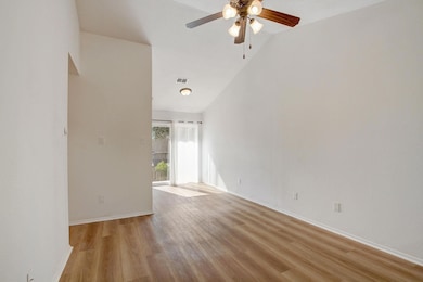 Unfurnished room featuring ceiling fan, light woo