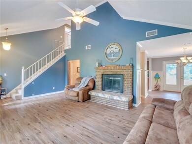 flooring, fireplace, and staircase.