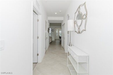 Hallway with recessed lighting and light tile patterned floors