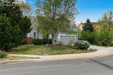 View of property hidden behind natural elements with an attached garage