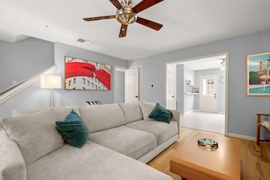 Living room featuring light wood-type flooring, c