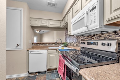 Kitchen with sink, white appliances, ceiling fan, 