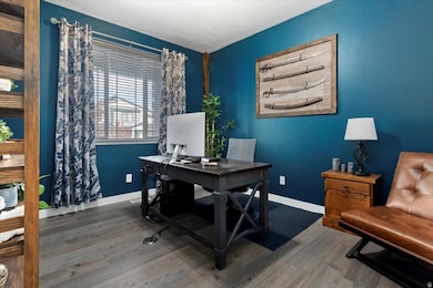 Home office featuring wood finished floors and baseboards