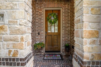 Solid Wood Front Door with 9 window design. Stone Exterior elevation arch way covered porch. Keyless entry and Ring Door Bell included.