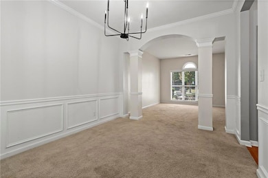 Unfurnished dining area featuring crown molding, a