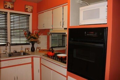 Kitchen has smooth-top burners on counter and a bu