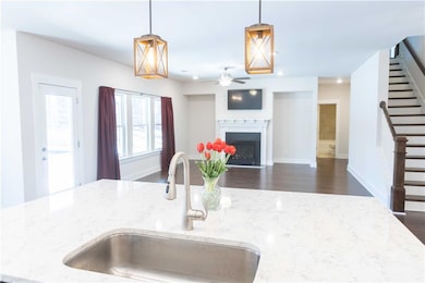 Kitchen featuring decorative light fixtures, sink,