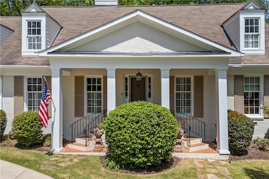 View of exterior entry with brick siding, roof wit