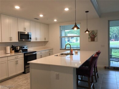 Kitchen featuring sink, range with electric stovetop, white cabinetry, and light tile patterned floors