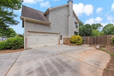 View of home's exterior with stone siding, drivewa