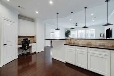The kitchen features a full-height bar area with n