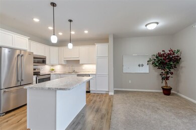 island with pendant lights and an outlet on the ot