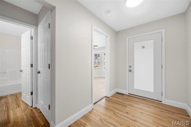 Entryway with baseboards and light wood finished floors
