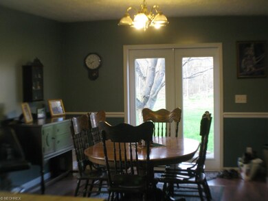 Eat-in kitchen dining area with doors to back yard