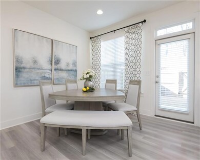 Dining space with light wood-style flooring and recessed lighting