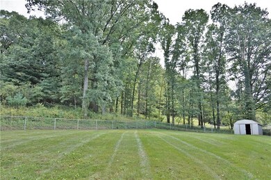 Mature trees outline the rear yard, fence is perfe