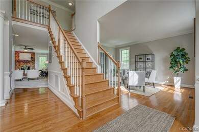 Stairs featuring chandelier, hardwood flooring, an