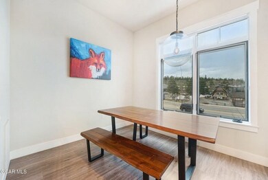 Dining space with wood finished floors and baseboa