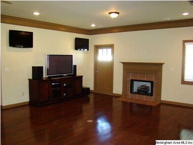 Family room has fireplace, hardwood floors and 3 f