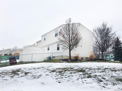 Back of home, with partially fenced back yard and 