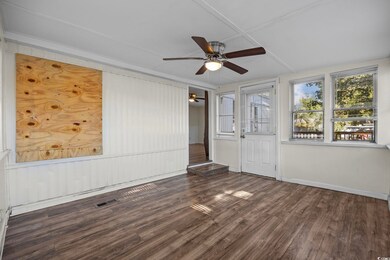 Spare room featuring ceiling fan and dark hardwood