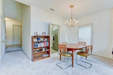 Dining room with a chandelier and light carpet