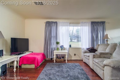 Living area featuring wood finished floors and baseboards