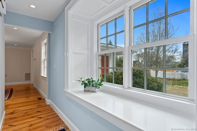A Charming Window Seat Frames The Front Entrance