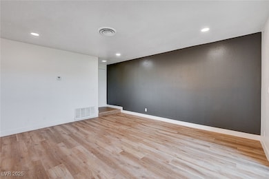 Empty room featuring baseboards, visible vents, an