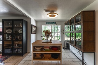 Dining space with a textured ceiling and light ti