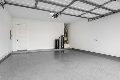 Garage with a garage door opener, water heater, b