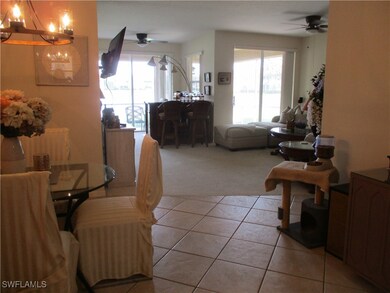 Tiled living room featuring ceiling fan