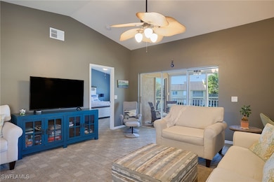Living room with light carpet, ceiling fan, and va