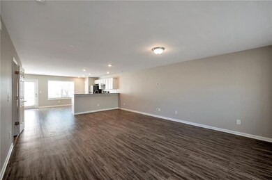 Unfurnished living room with dark wood-style floor