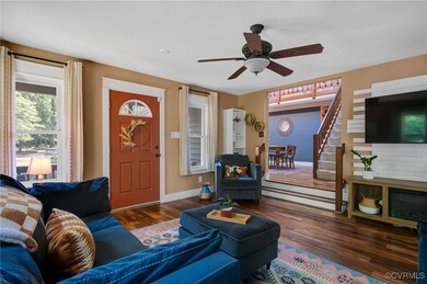 Living area with stairway, wood finished floors, a