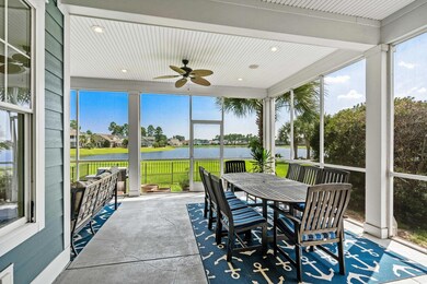 Sunroom featuring ceiling fan, a water view, and a