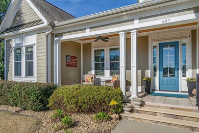 View of exterior entry with covered porch, ceiling