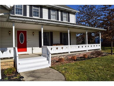 FRONT ENTRANCE WITH COVERED WRAP AROUND PORCH.