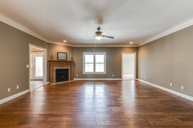 The Great Room has hardwood floors, a corner fireplace and opens to the kitchen and a separate den.  