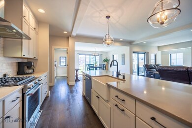 Custom lighting accents the farmhouse sink and mod