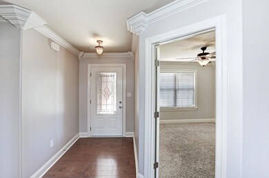 Foyer - With laminate flooring, smooth ceiling and extensive crown molding.