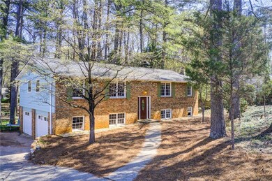 Split foyer home featuring driveway, brick siding,