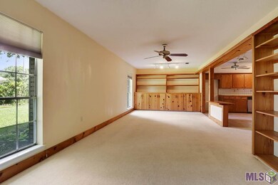 To the left of the front door is the formal living