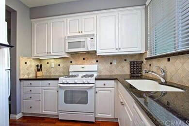 Spacious kitchen with black granite counter tops.